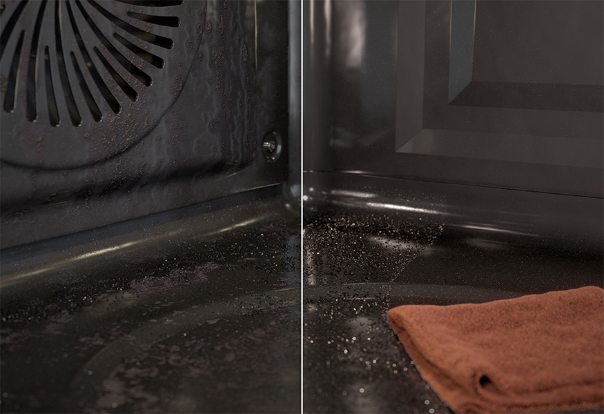 Oven being cleaned with towel