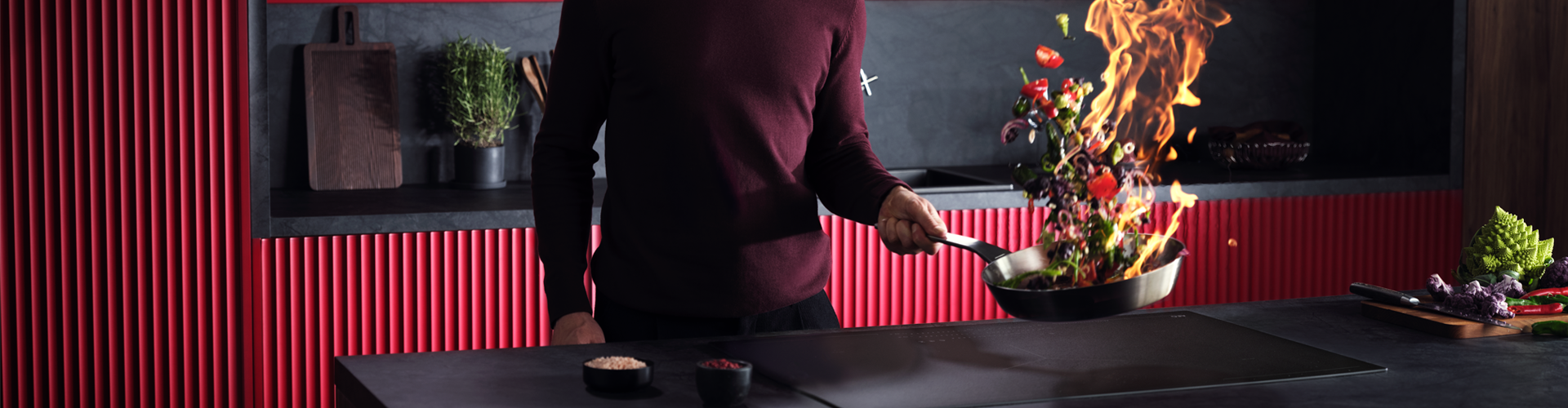 Man cooking food on cooktop with flame