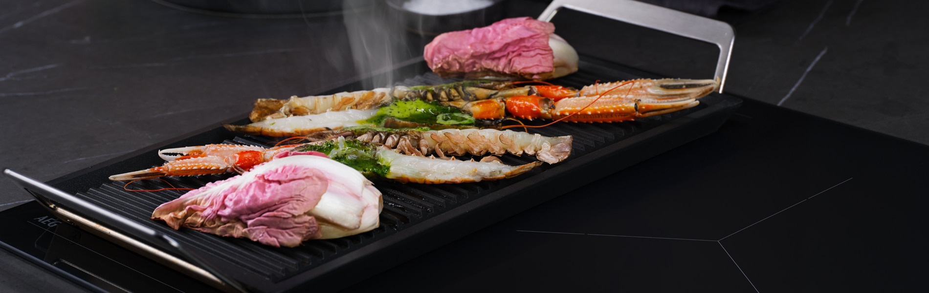 Placha grill cooking food on cooktop