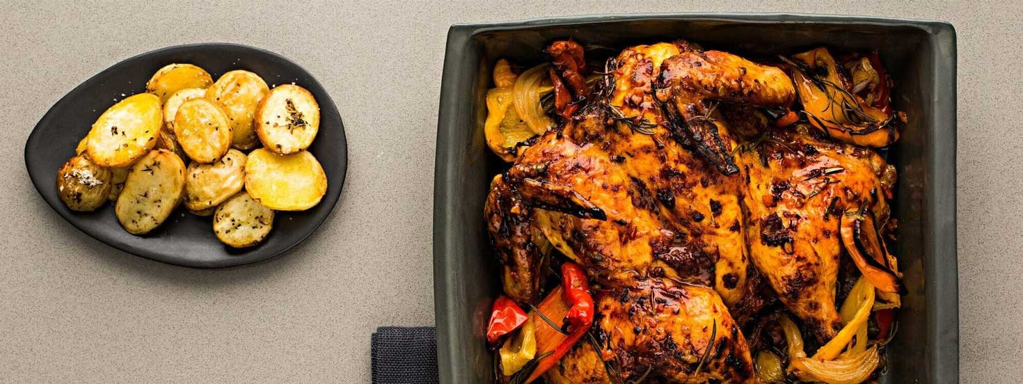 BUTTERFLIED CHICKEN MARINATED WITH SMOKY PEPPER RELISH AND CHAT POTATOES